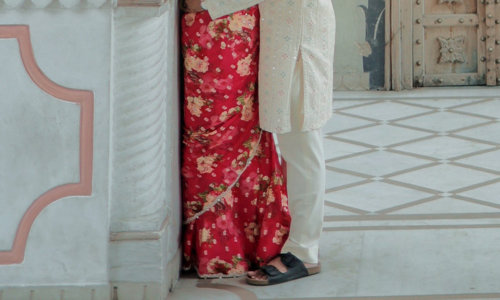 Pre-wedding couple embrace at heritage haveli